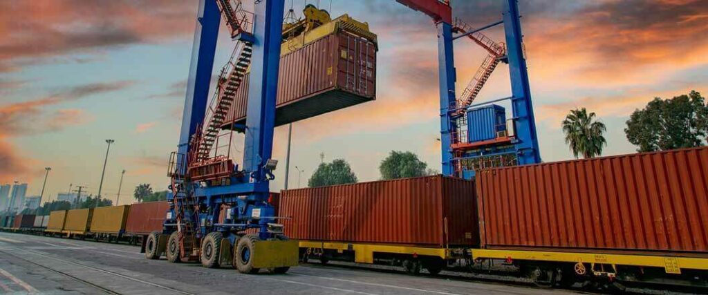 A container at a port being loaded onto a train