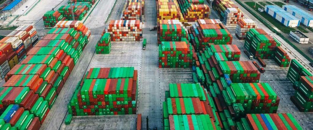 Multicolored cargo containers neatly stacked at a port