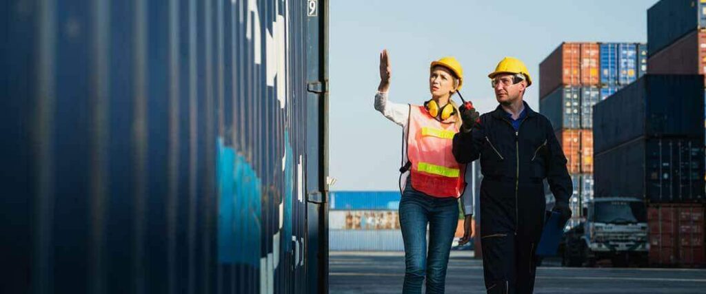 Two CBP officials discuss a container about to be pulled for inspection