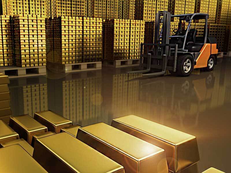 An image depicting stacks of palletized gold bars in a warehouse, reflecting the article's subject matter: importing gold into the U.S.