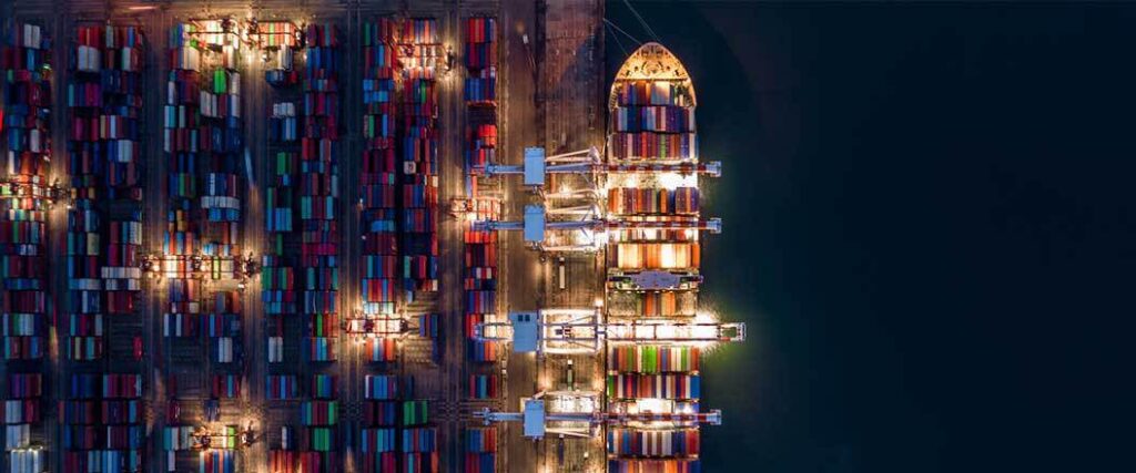 Overhead view of a cargo ship and port at night