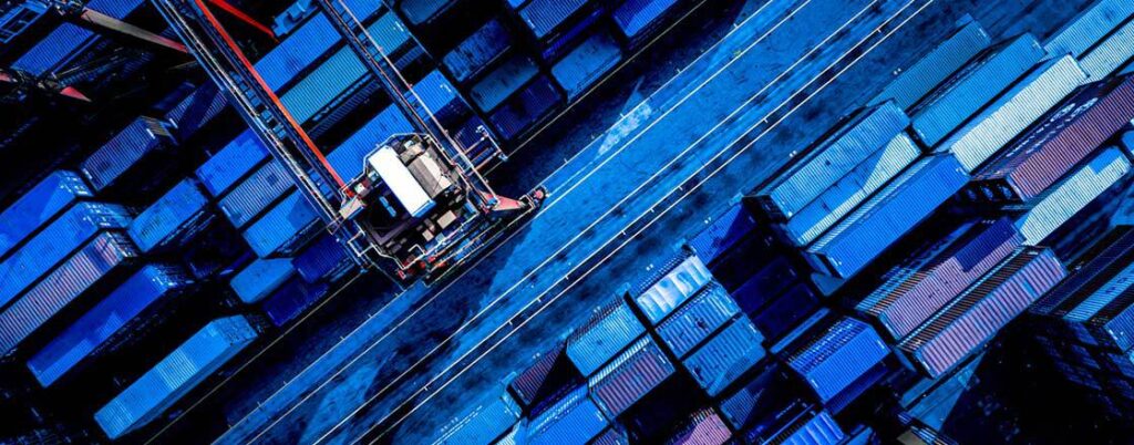 Aerial view of cargo containers and a crane at a port