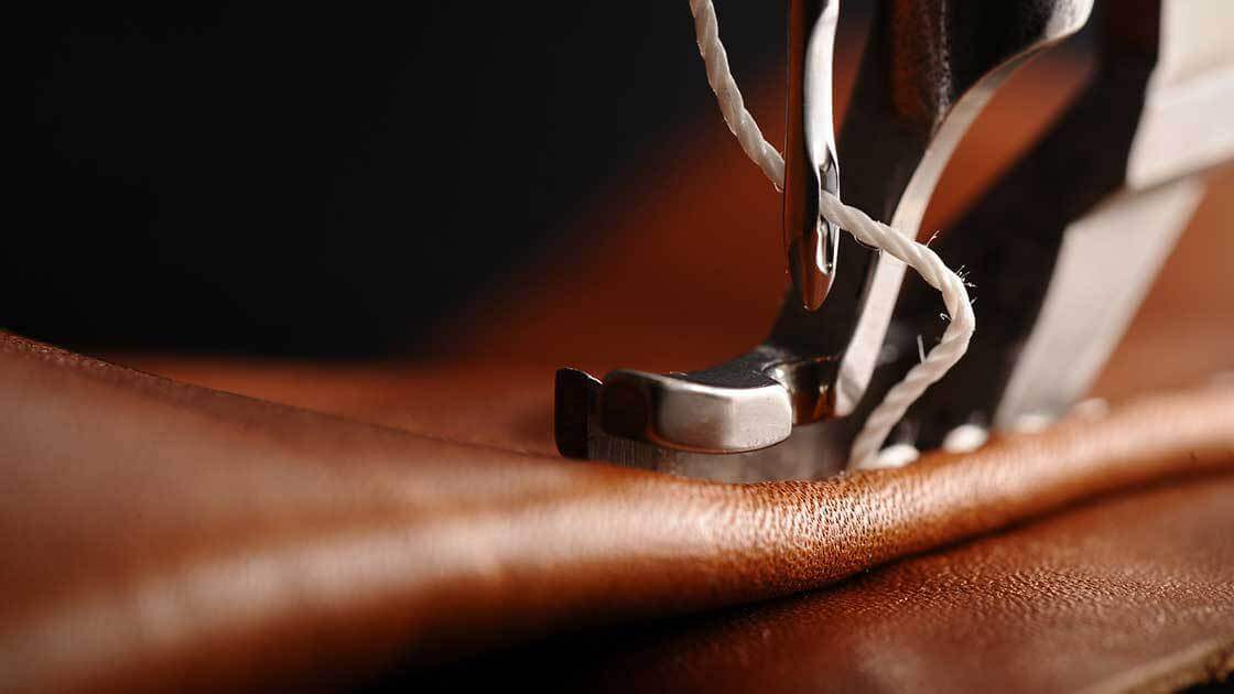 close up of sewing machine on leather