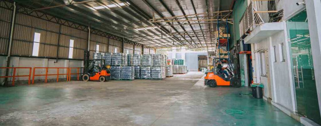 A warehouse with forklifts and palletized freight