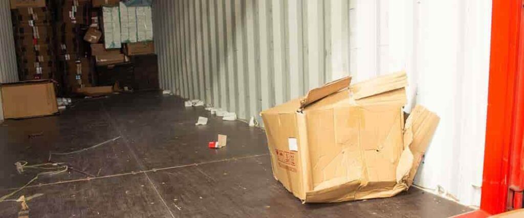 A damaged box inside of a cargo container