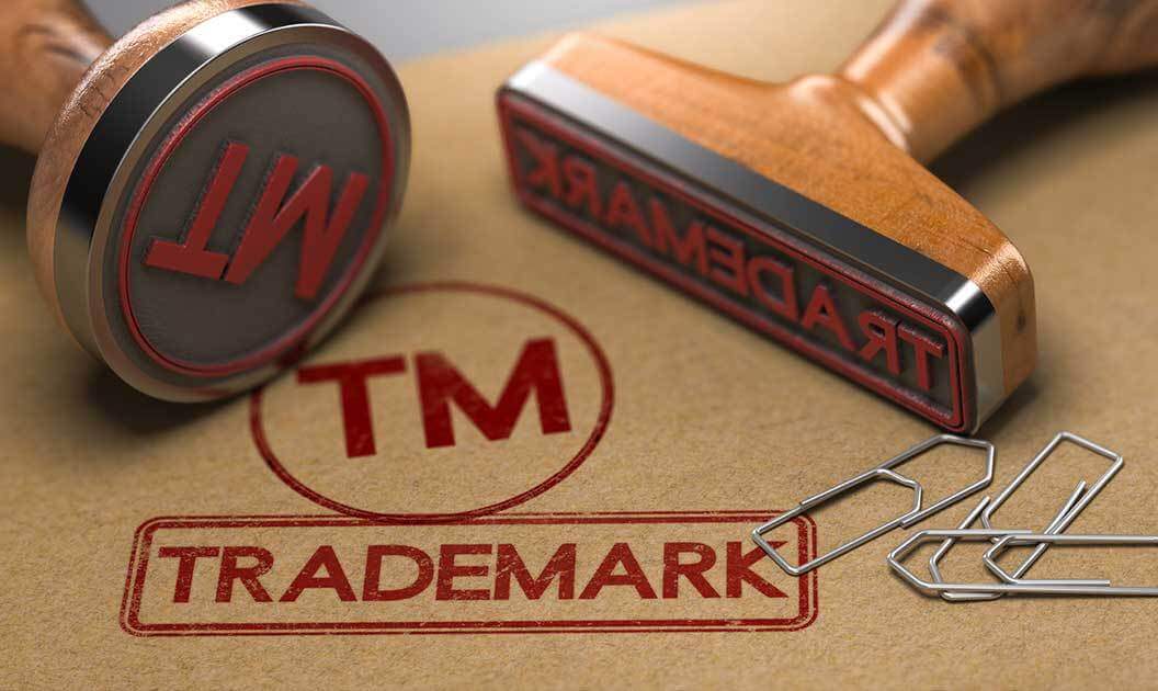 A file folder stamped with the word trademark and the TM symbol. The stamps themselves are also visible.