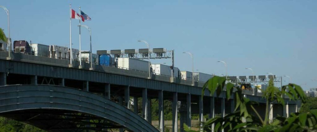 Semi trucks lined up at the U.S and Canada border.