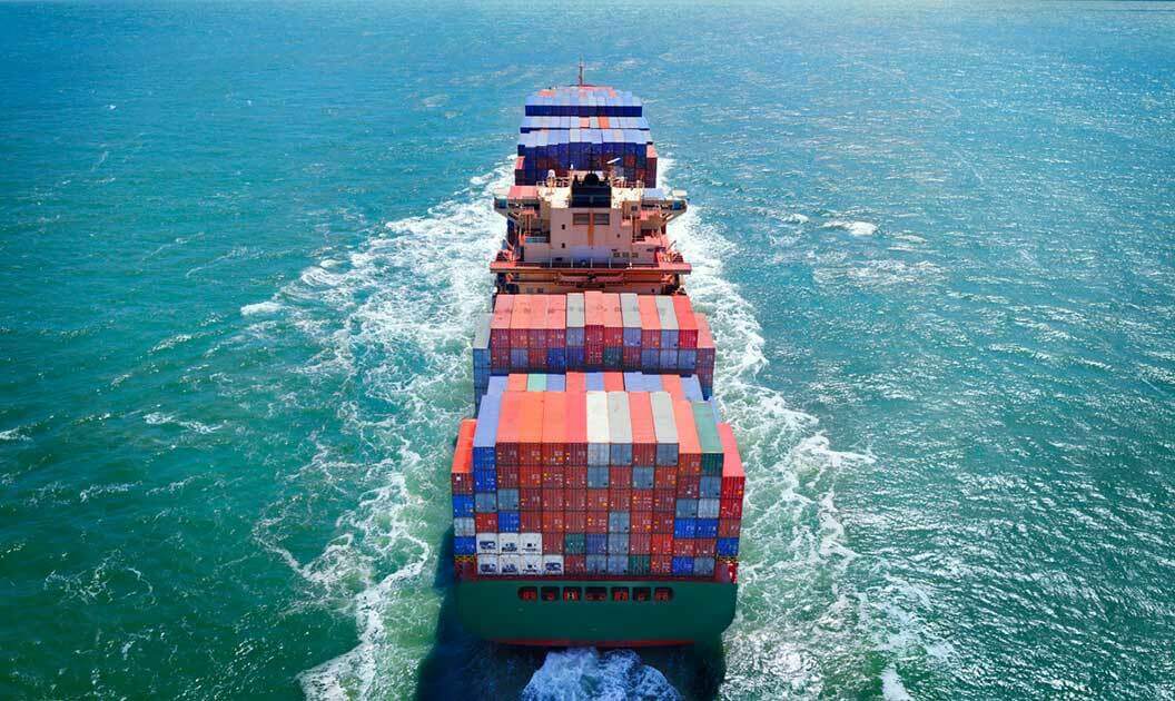 A fully-loaded container vessel at sea.