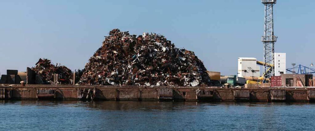 Importing scrap metal, such as the large pile seen here next to shore, is common in the United States.