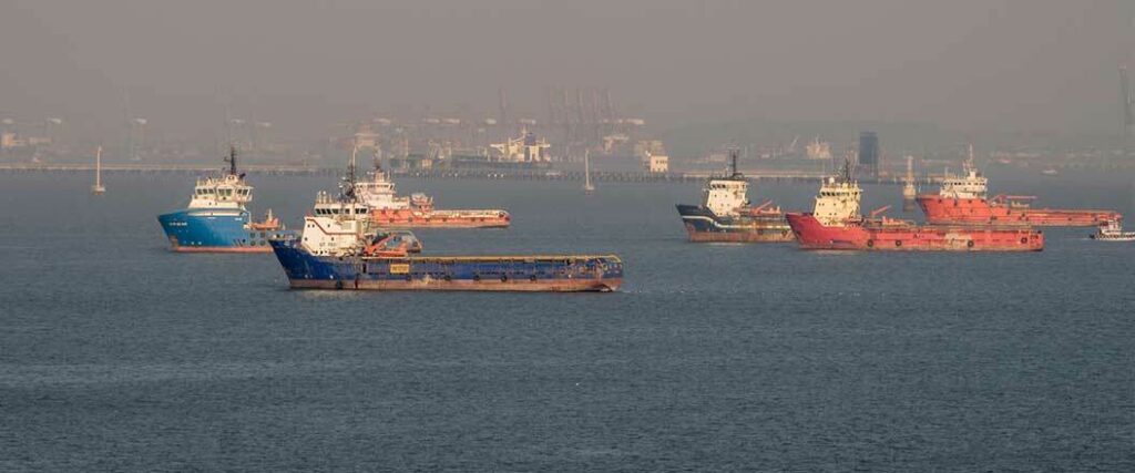 Six empty cargo vessels on their way to port.