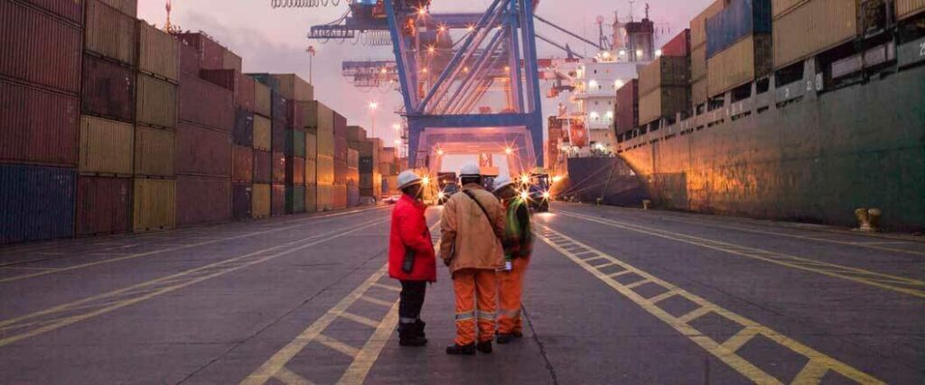 Longshoremen gathered on a port terminal. 