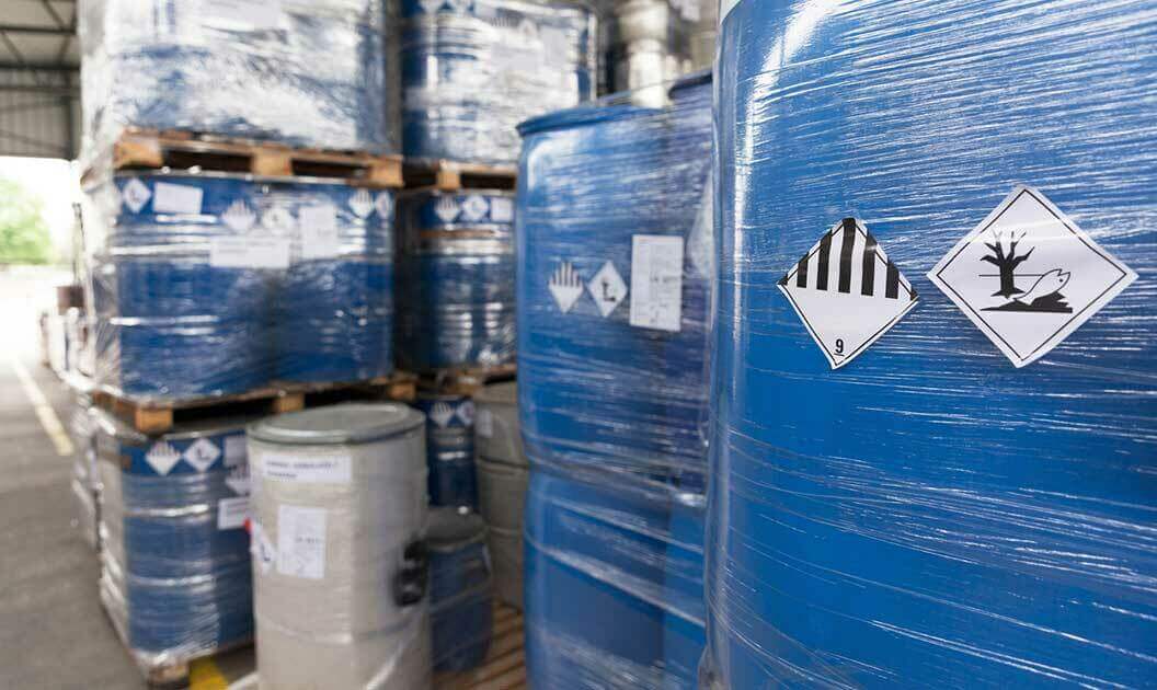 Palletized and wrapped chemicals in a warehouse awaiting shipment.